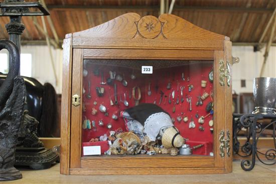 Wall hanging corner cabinet, with a display of dolls house furniture and fittings